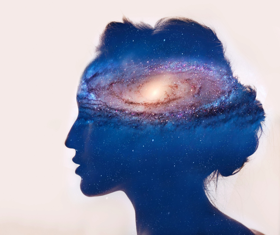Silhouette of a woman with a picture of the universe inside her mind.