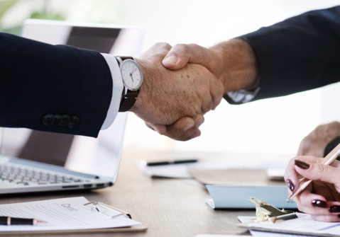 Business people shaking hands together