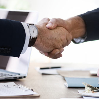 Business people shaking hands together
